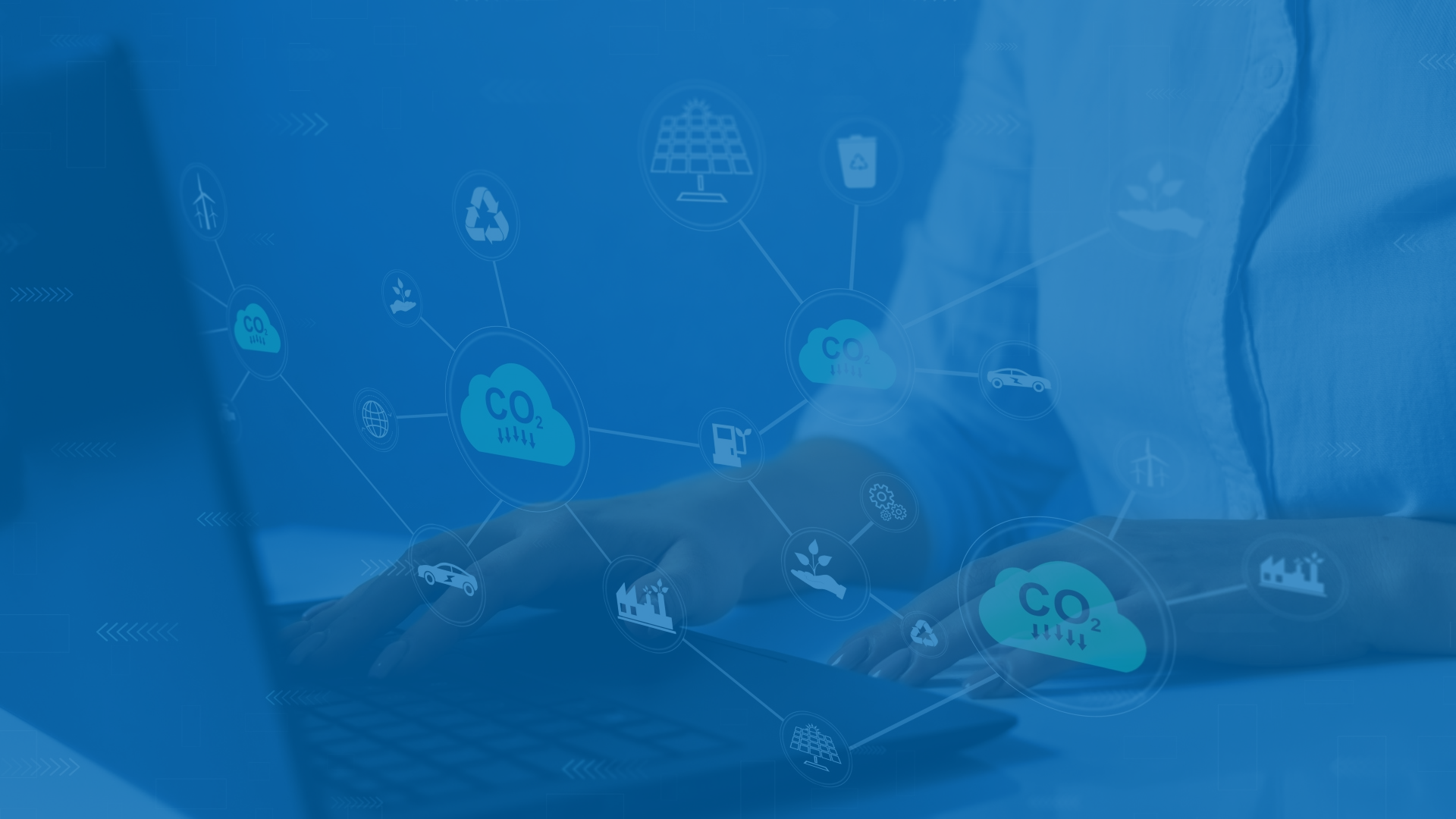 Person using a laptop with digital icons overlay showing CO2 emissions and sustainability symbols related to environmental data and analysis.