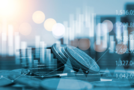 Stacks of coins with financial graphs and data overlays, representing financial growth, investment, or market analysis.