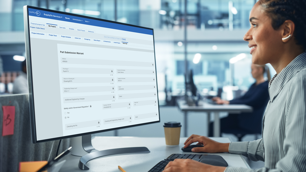 Person working at a desk, using a desktop computer displaying a form titled Part Submission Warrant in an office environment.