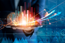 A person holds a tablet with rising bar graphs, glowing effects, and upward arrows, symbolising business growth and digital analytics.